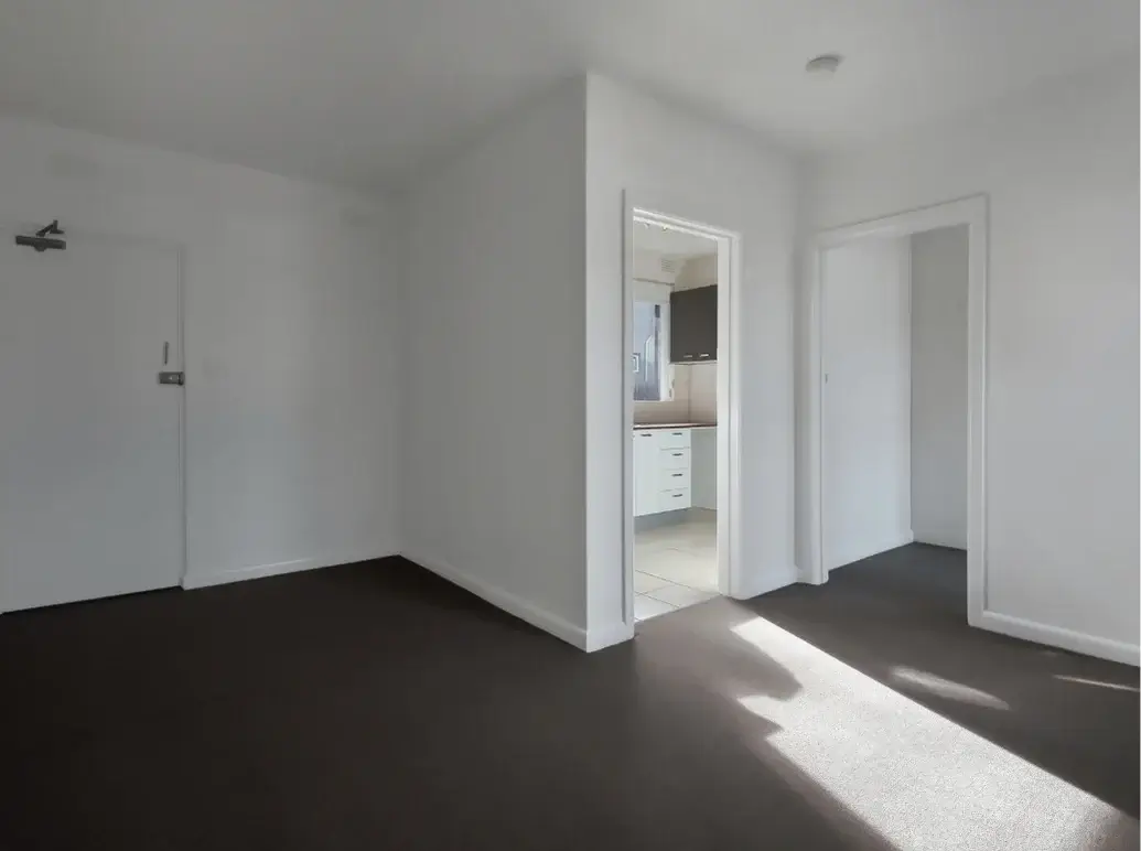 Professional cleaner vacuuming an empty home during move-in and move-out cleaning in Central Massachusetts